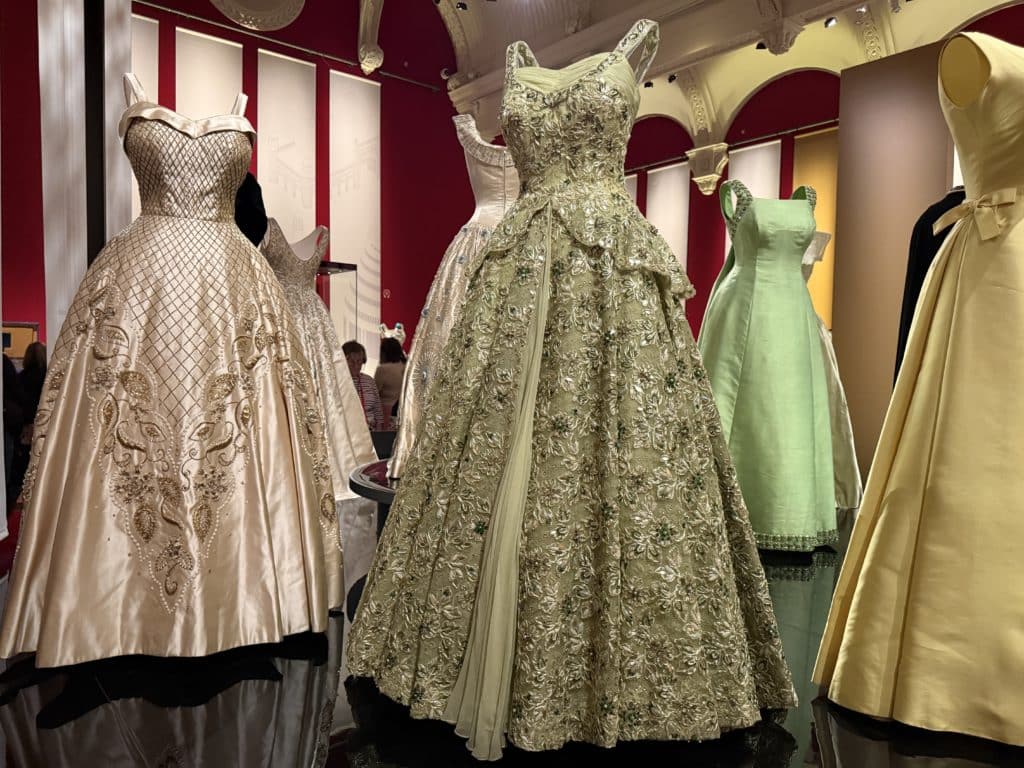 Several of Queen Elizabeth IIs evening gowns, embellished with crystals and pearls